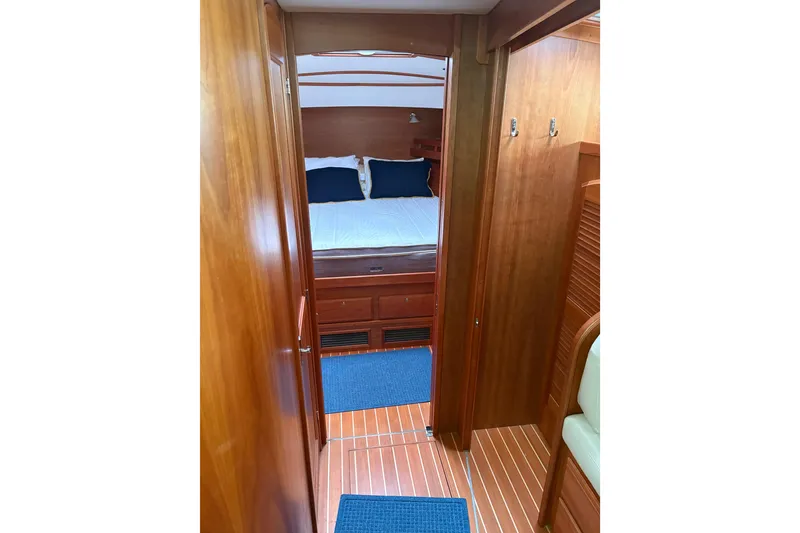 Slide: The Image of 2020 Sabre 42 Salon Express cabin interior with wooden finish and cozy bedding. - 11