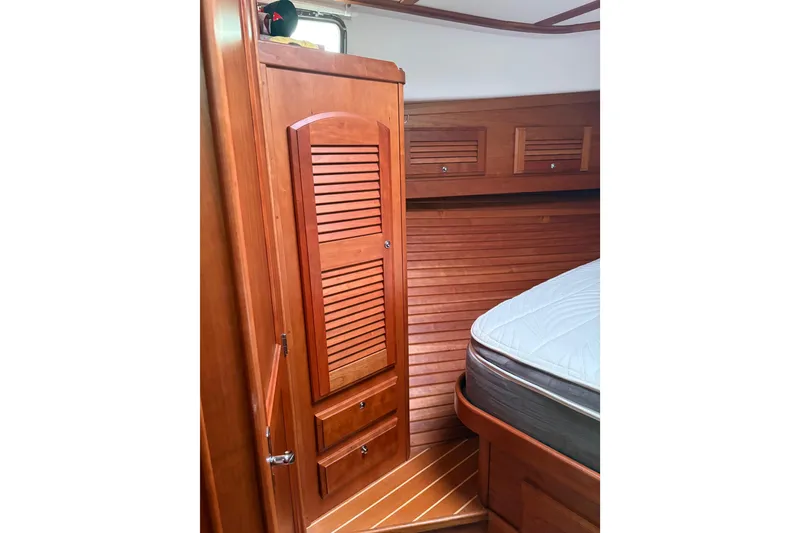 Slide: The Image of Interior of 2020 Sabre 42 Salon Express with wooden cabinetry and bed. - 13