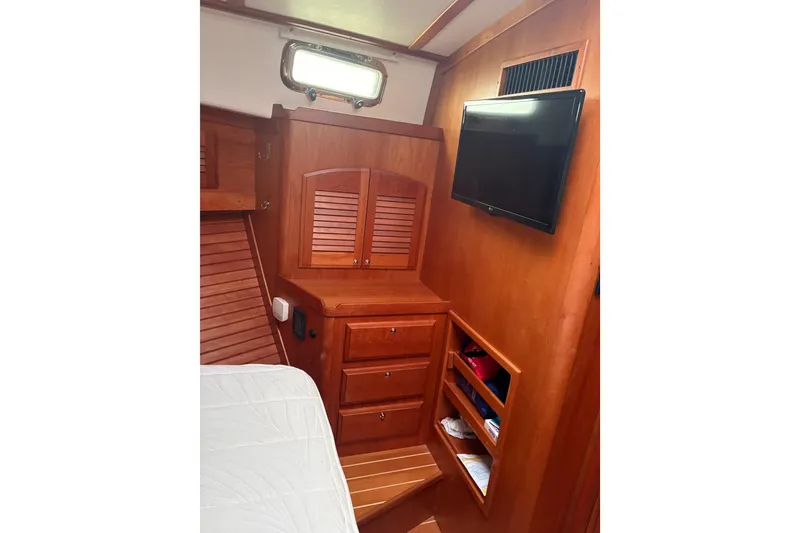 Slide: The Image of Interior of 2020 Sabre 42 Salon Express with wooden cabinetry and mounted TV. - 14