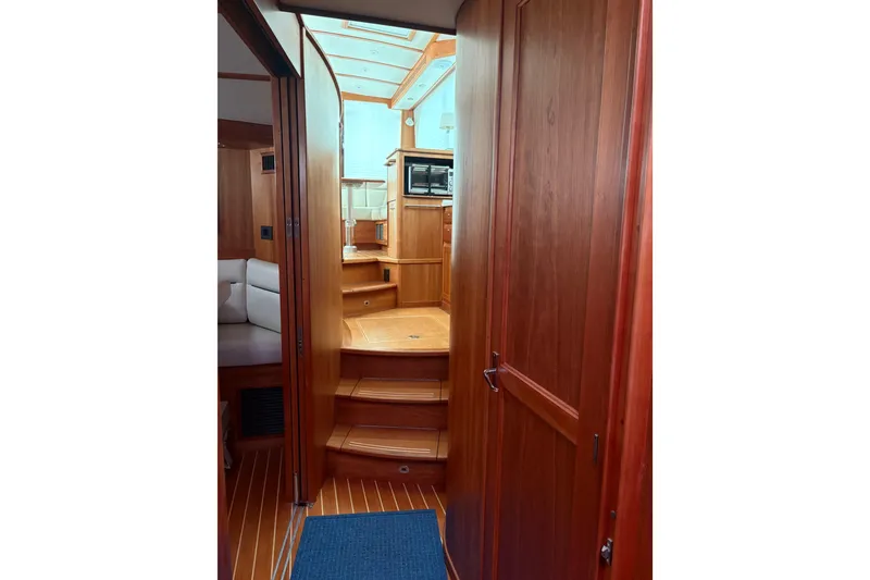 Slide: The Image of Interior view of 2020 Sabre 42 Salon Express yacht, featuring wooden cabinetry and steps. - 15