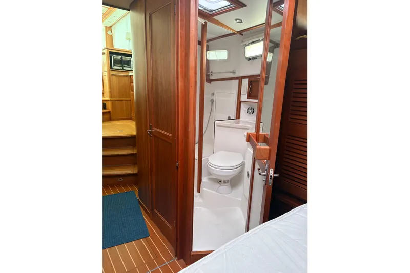 Slide: The Image of 2020 Sabre 42 Salon Express bathroom with wooden cabinetry and modern fixtures. - 16