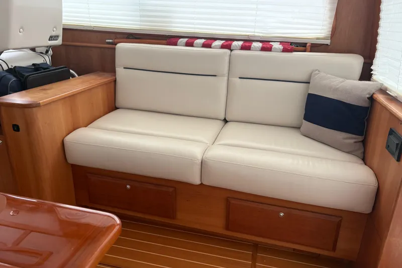 Slide: The Image of Elegant interior of 2020 Sabre 42 Salon Express with cream sofa and striped cushion. - 2