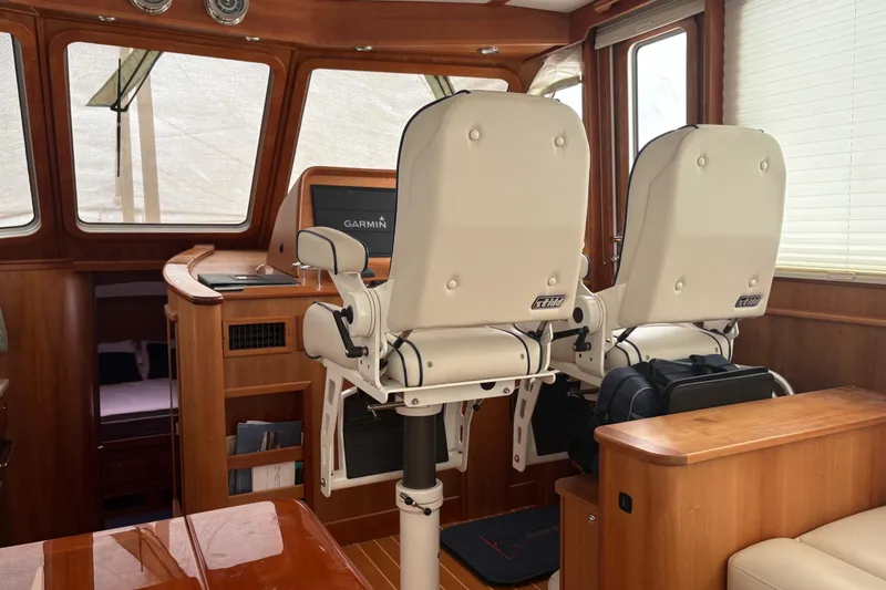 Slide: The Image of Interior of 2020 Sabre 42 Salon Express with helm chairs and navigation equipment. - 3