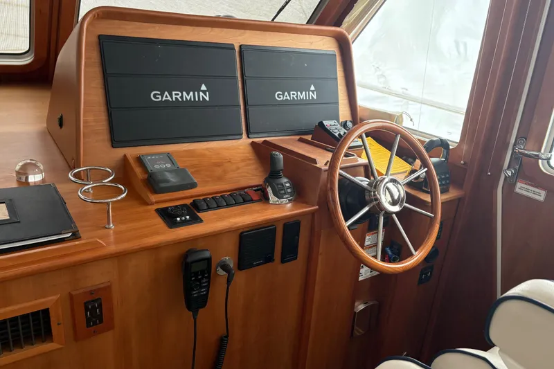 Slide: The Image of 2020 Sabre 42 Salon Express helm with Garmin navigation displays and wooden steering wheel. - 4