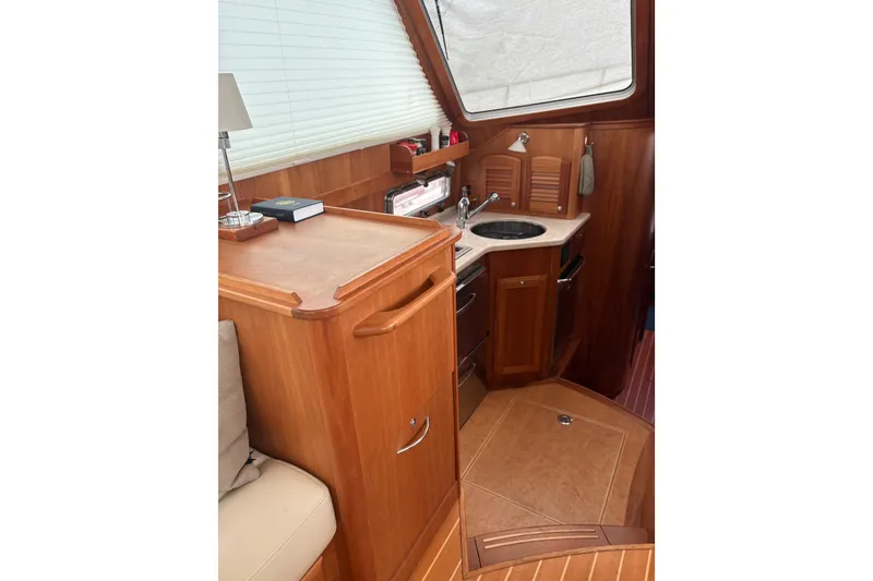 Slide: The Image of Interior of 2020 Sabre 42 Salon Express yacht with wooden cabinetry and compact kitchen. - 5
