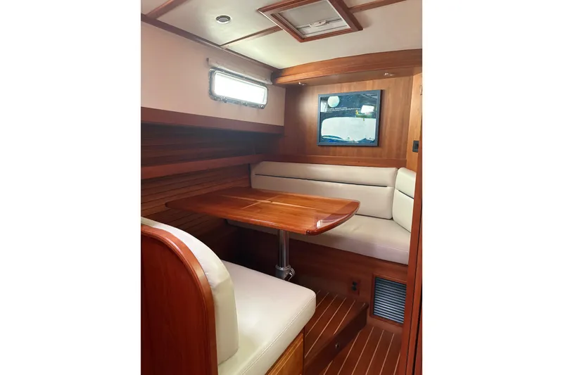 Slide: The Image of Interior of 2020 Sabre 42 Salon Express, featuring elegant wood finish and cozy seating area. - 8
