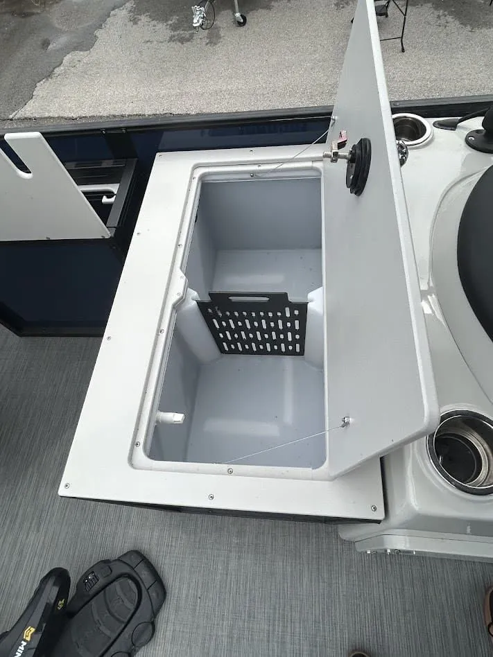 Slide: The Image of Open storage compartment on a 2024 Lowe SS214 boat. - 11