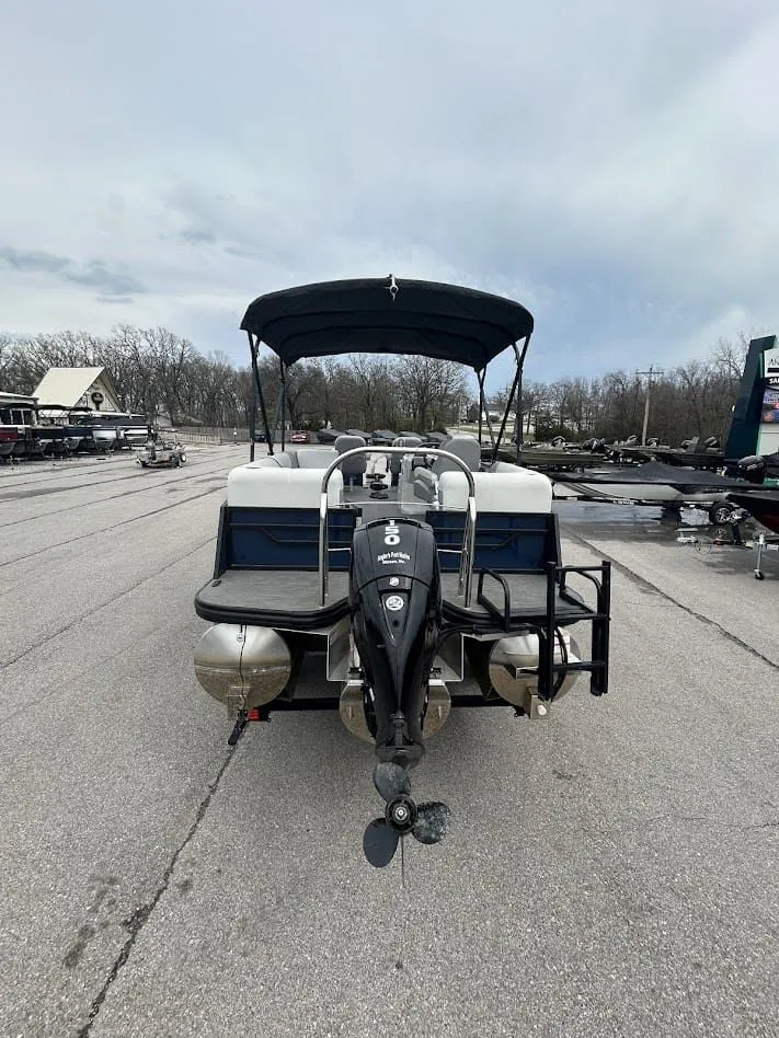 Slide: The Image of 2024 Lowe SS214 pontoon boat with outboard motor on parking lot. - 2