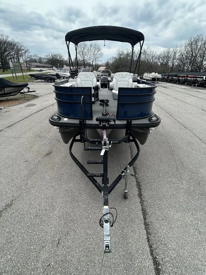 Slide: The Image of 2024 Lowe SS214 pontoon boat on trailer, overcast sky. - 5