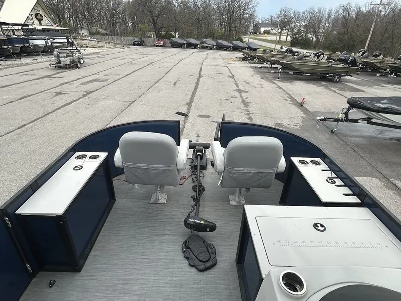 Slide: The Image of 2024 Lowe SS214 pontoon boat on lot with empty seats. - 9