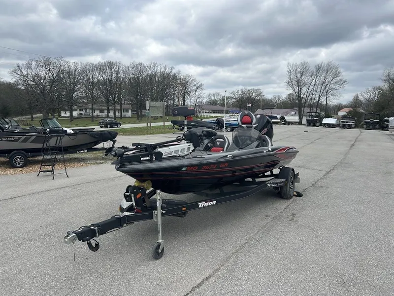 Slide: The Image of 2021 Triton 18TRX boat on trailer, cloudy sky. - 10