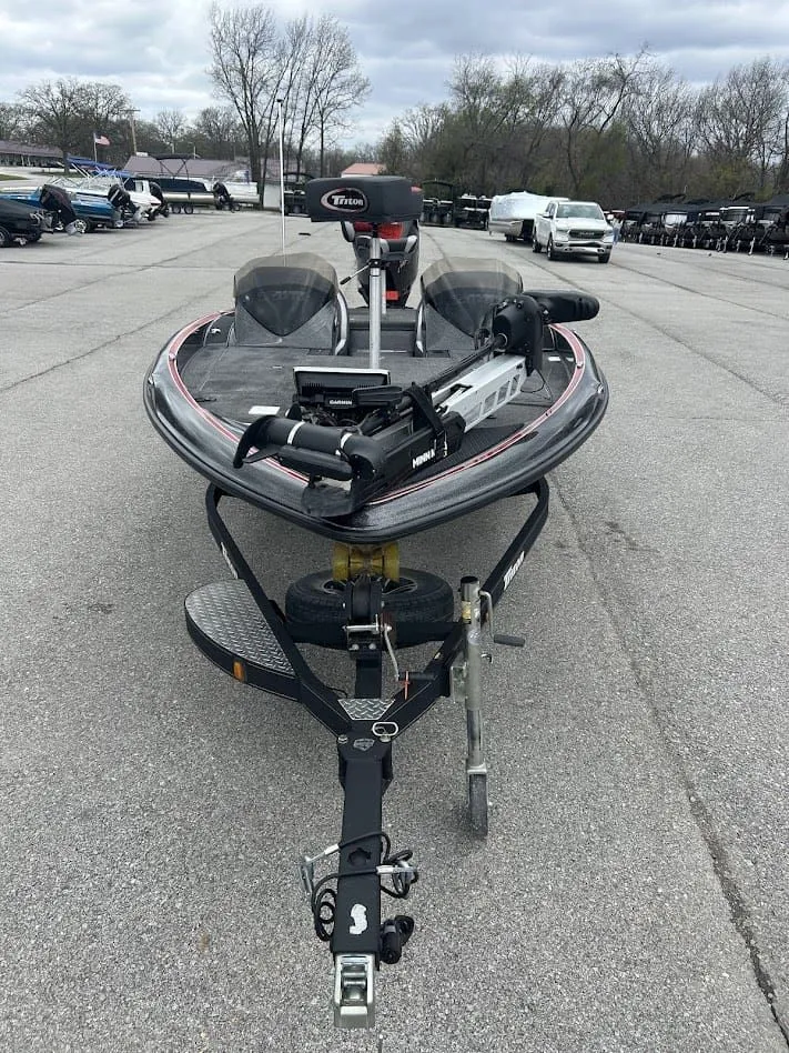 Slide: The Image of 2021 Triton 18TRX boat on trailer in parking lot. - 11