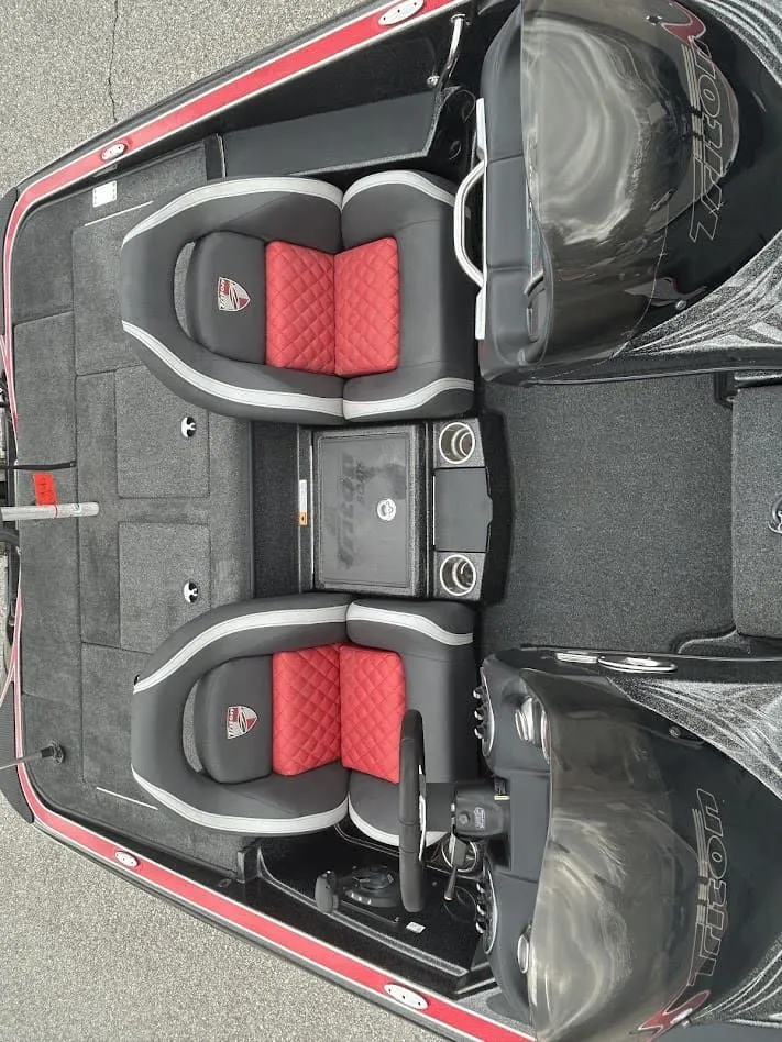Slide: The Image of Interior of a 2021 Triton 18TRX boat with red and gray seats. - 16