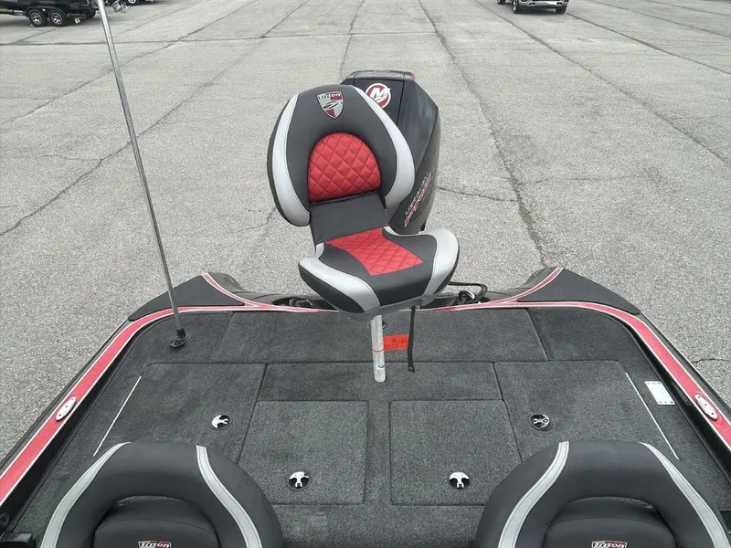 Slide: The Image of Triton 18TRX 2021 boat with red and black seat on gray deck. - 2