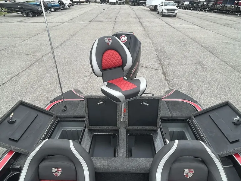 Slide: The Image of 2021 Triton 18TRX boat with red and gray seats on parking lot. - 3