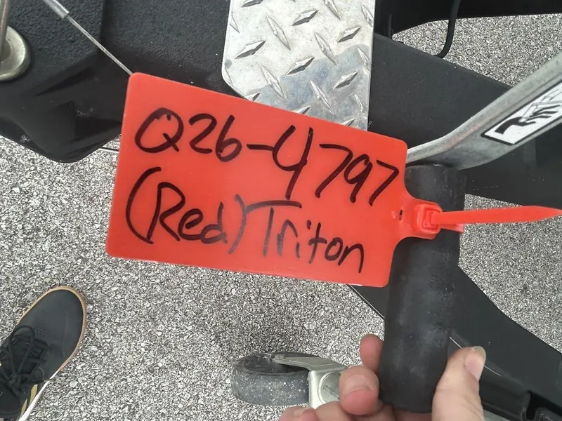 Slide: The Image of Red tag labeled "Q26-4797 (Red) Triton" on a vehicle. - 5