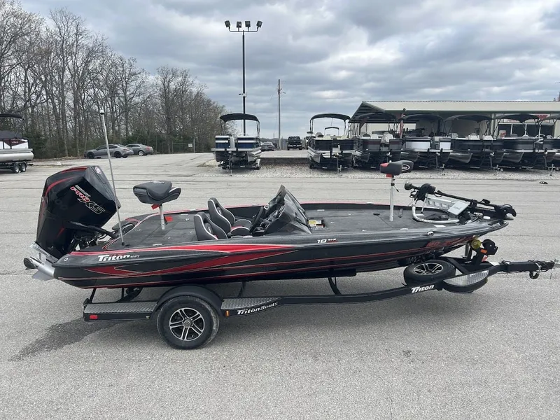 Slide: The Image of 2021 Triton 18TRX boat parked on trailer outdoors. - 6