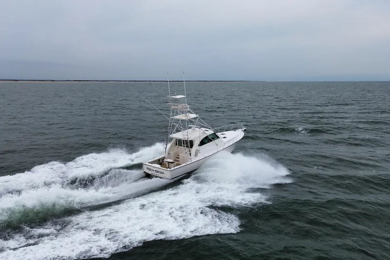 Slide: The Image of 2016 Henriques 42 Express Hardtop cruising on open water, creating a dynamic wake. - 3