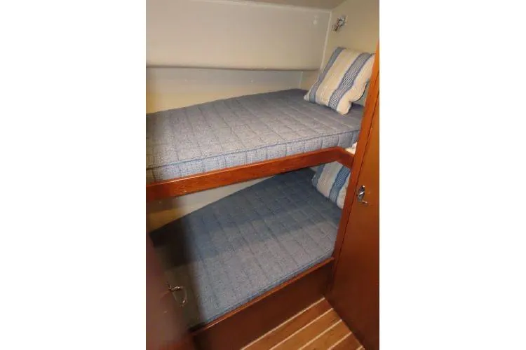 Slide: The Image of Bunk beds in 2011 Henriques 42 Flybridge cabin with striped bedding. - 11