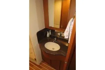 Slide: The Image of 2011 Henriques 42 Flybridge bathroom with sink, mirror, and wooden cabinetry. - 12