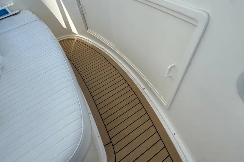 Slide: The Image of Henriques 42 Flybridge 2011 boat interior with teak flooring and white seating. - 20