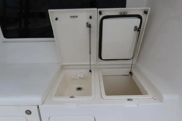 Slide: The Image of Henriques 42 Flybridge 2011 boat storage compartments with open lids. - 25