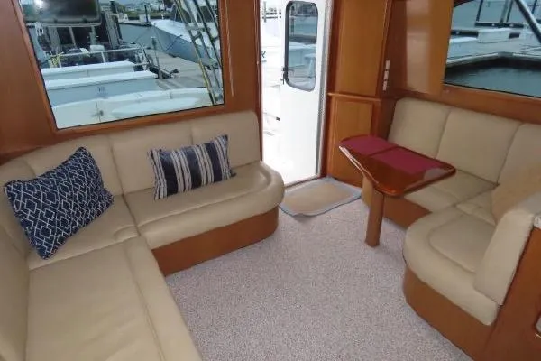 Slide: The Image of Luxurious interior of 2011 Henriques 42 Flybridge yacht with beige seating and decorative pillows. - 3