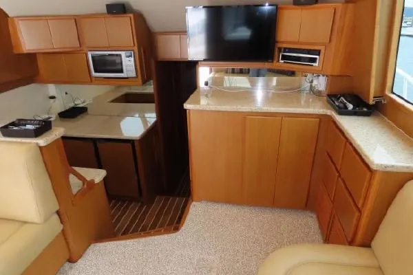 Slide: The Image of Interior of 2011 Henriques 42 Flybridge yacht with modern kitchen and entertainment area. - 7