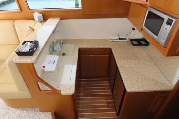 Slide: The Image of Henriques 42 Flybridge 2011 yacht kitchen with modern appliances and sleek countertops. - 8