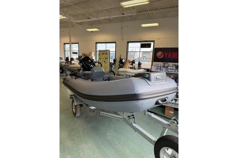 Slide: The Image of 2026 Desner CL 360 FCT inflatable boat displayed in showroom on trailer. - 1