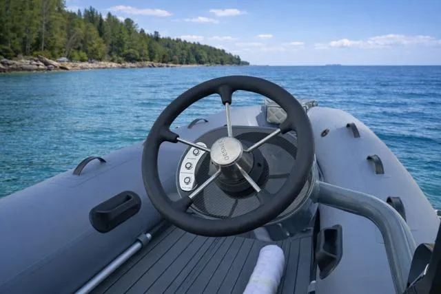 Slide: The Image of Steering wheel of 2026 Desner CL 360 FCT boat on serene lake. - 5