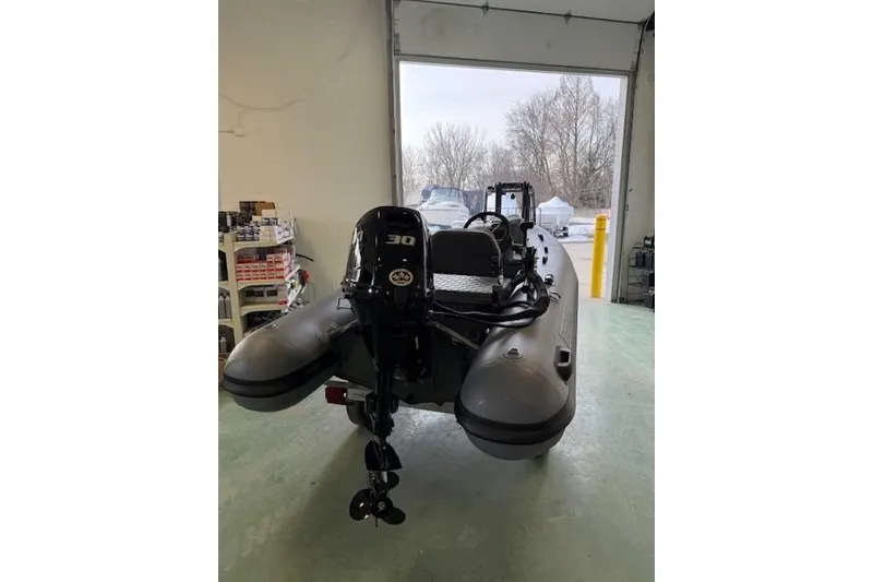 Slide: The Image of 2026 Desner CL 360 FCT inflatable boat with 30 HP motor in a garage setting. - 9