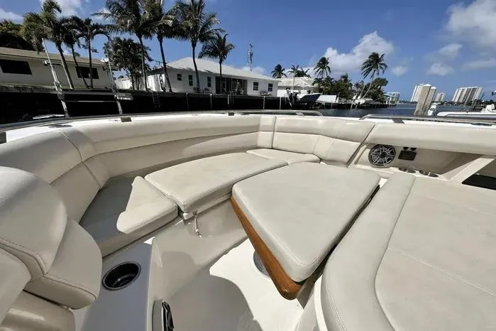 Slide: The Image of 2019 Boston Whaler 350 Realm boat interior with luxurious seating and waterfront view. - 5