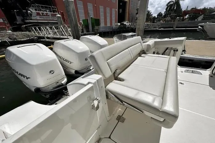 Slide: The Image of 2019 Boston Whaler 350 Realm boat with triple Mercury outboard engines and comfortable seating. - 7