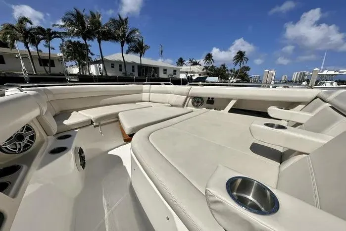 Slide: The Image of 2019 Boston Whaler 350 Realm boat interior with luxurious seating and cup holders. - 8