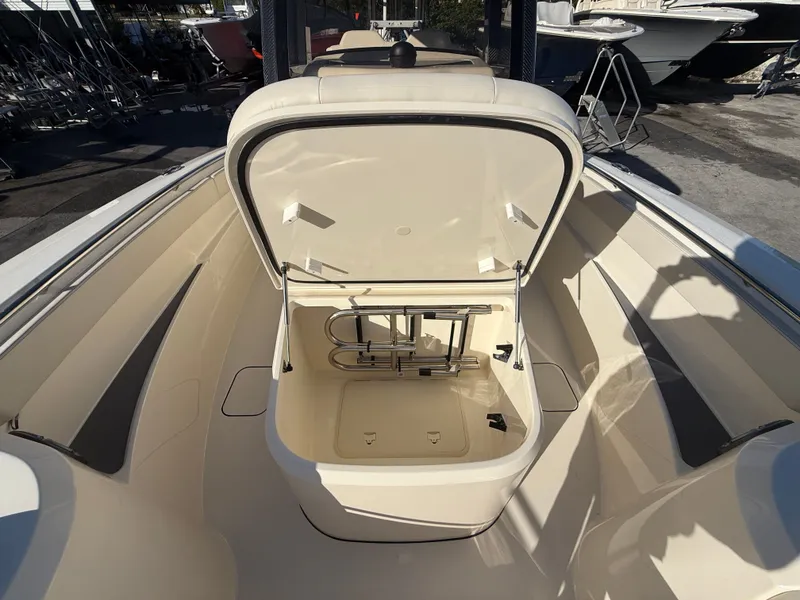 Slide: The Image of Scout 288 LXF 2026 boat with open storage compartment lid. - 13
