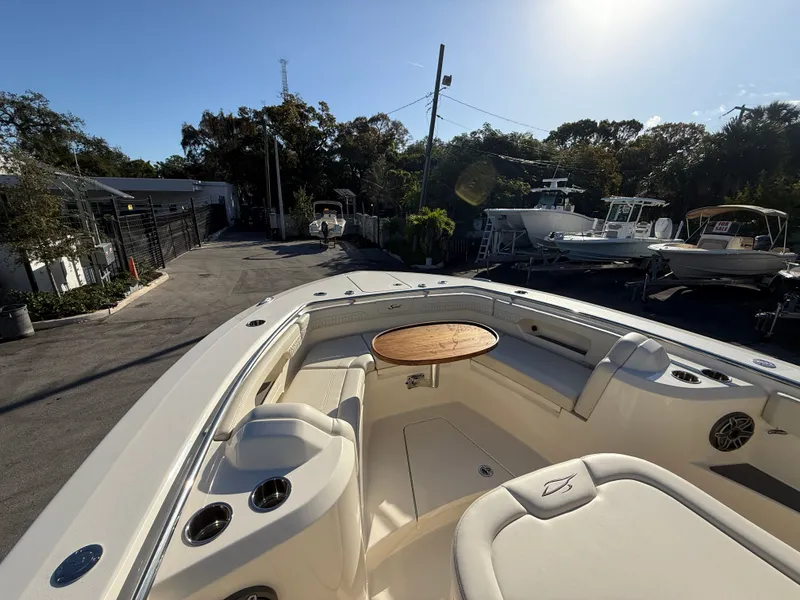 Slide: The Image of Scout 288 LXF 2026 boat with outdoor seating and table. - 14