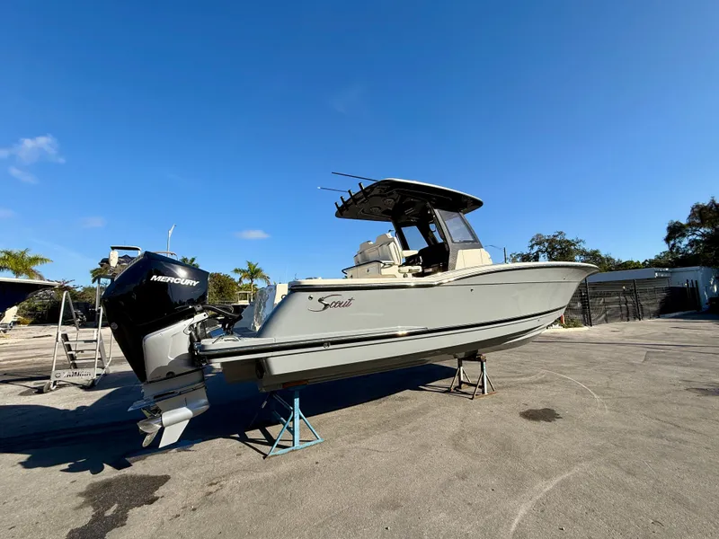 Slide: The Image of Scout 288 LXF 2026 boat on stands outdoors. - 16