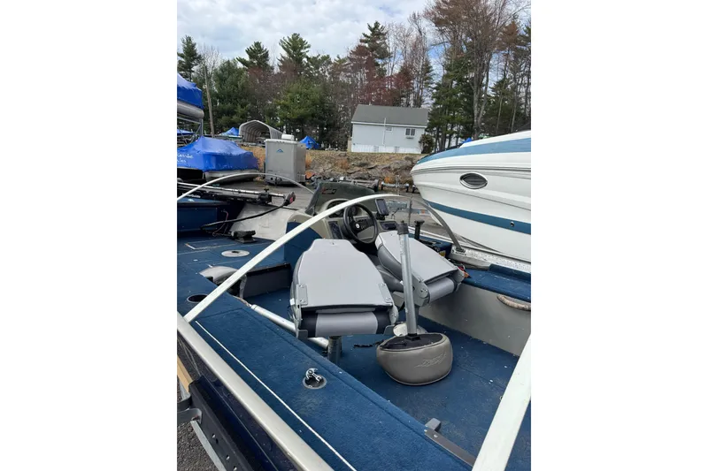 Slide: The Image of 2002 Lund 1650 Explorer SS boat interior with blue carpet and seating. - 6