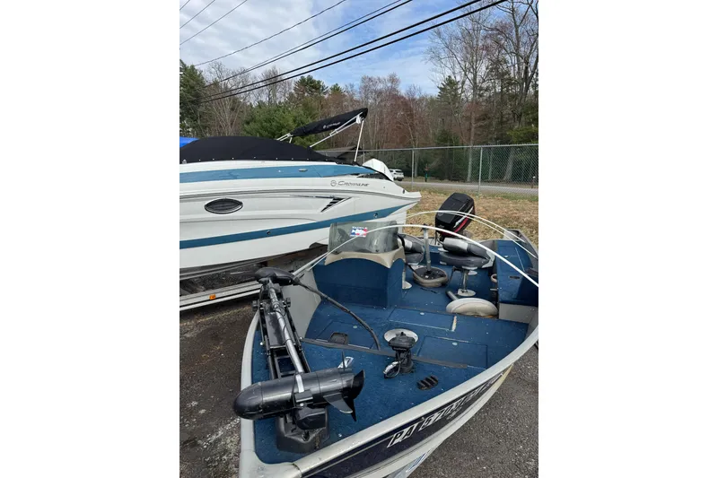 Slide: The Image of 2002 Lund 1650 Explorer SS boat parked outdoors near another vessel. - 7