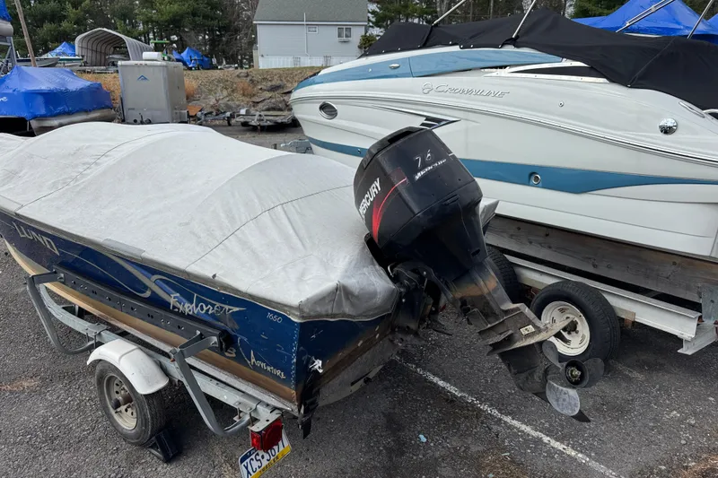 Slide: The Image of 2002 Lund 1650 Explorer SS boat with Mercury outboard motor, covered and on trailer. - 8