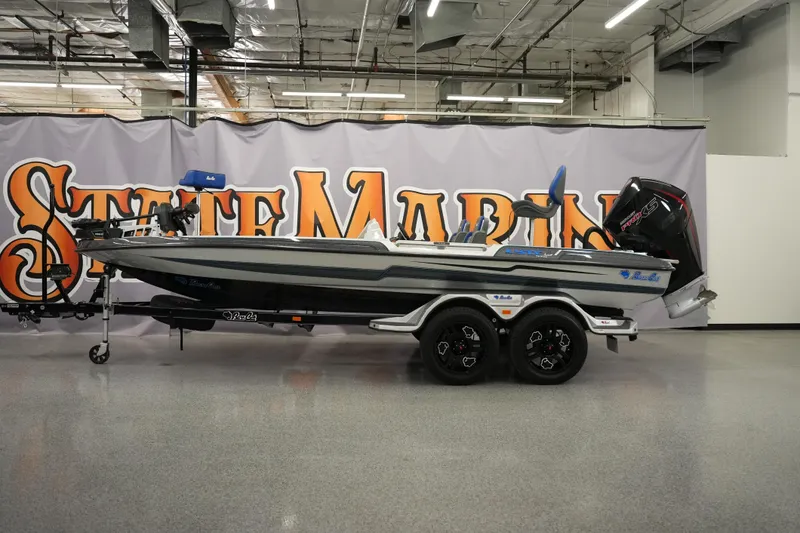 The Image of 2026 Bass Cat Lynx STS boat displayed indoors with a sleek design and modern features. - 1