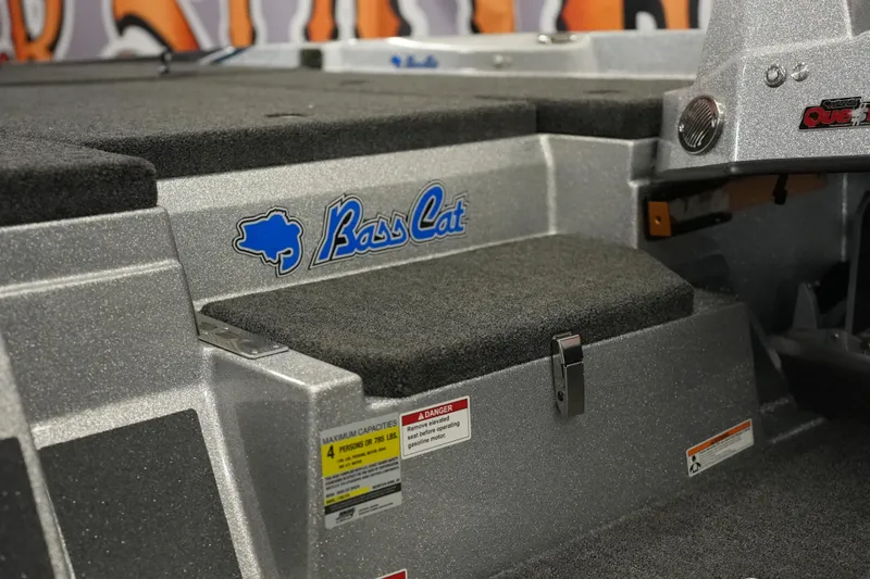 Slide: The Image of 2026 Bass Cat Lynx STS boat interior with logo and carpeted steps. - 11