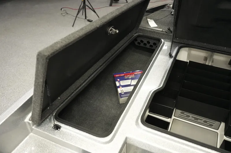 Slide: The Image of 2026 Bass Cat Lynx STS storage compartment with Lucas Oil product inside. - 18