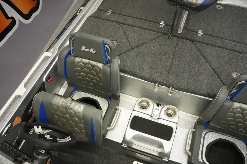 Slide: The Image of 2026 Bass Cat Lynx STS interior with gray and blue seats, steering wheel, and cup holders. - 22