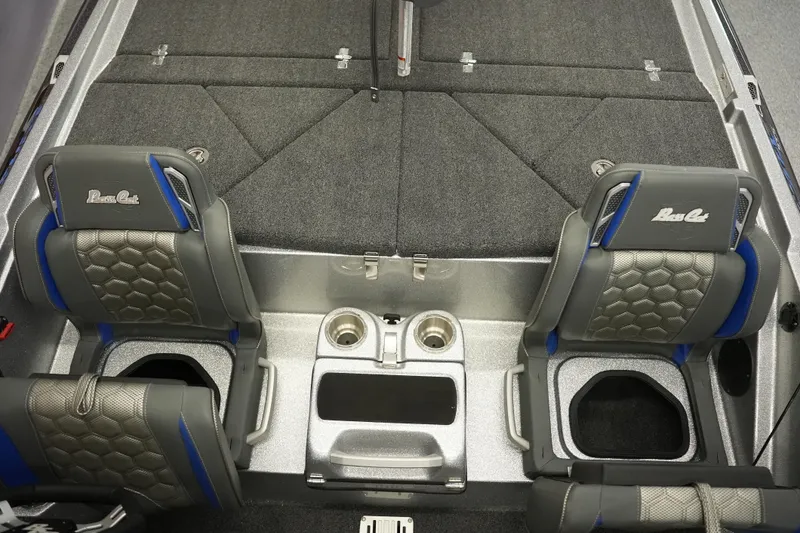 Slide: The Image of 2026 Bass Cat Lynx STS boat interior with gray seats and storage compartments. - 24