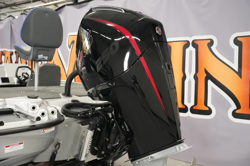 Slide: The Image of 2026 Bass Cat Lynx STS boat with powerful black and red outboard motor. - 6