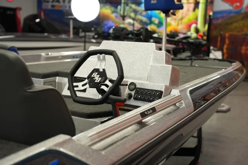 Slide: The Image of 2026 Bass Cat Lynx STS boat interior with steering wheel and control panel. - 7