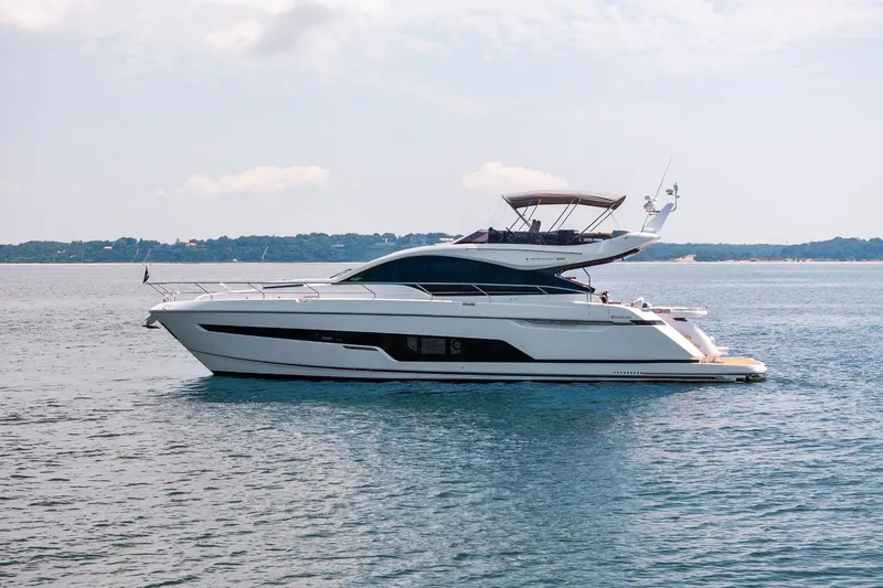 The Image of 2024 Fairline Phantom 65 yacht on calm water, side view. - 0
