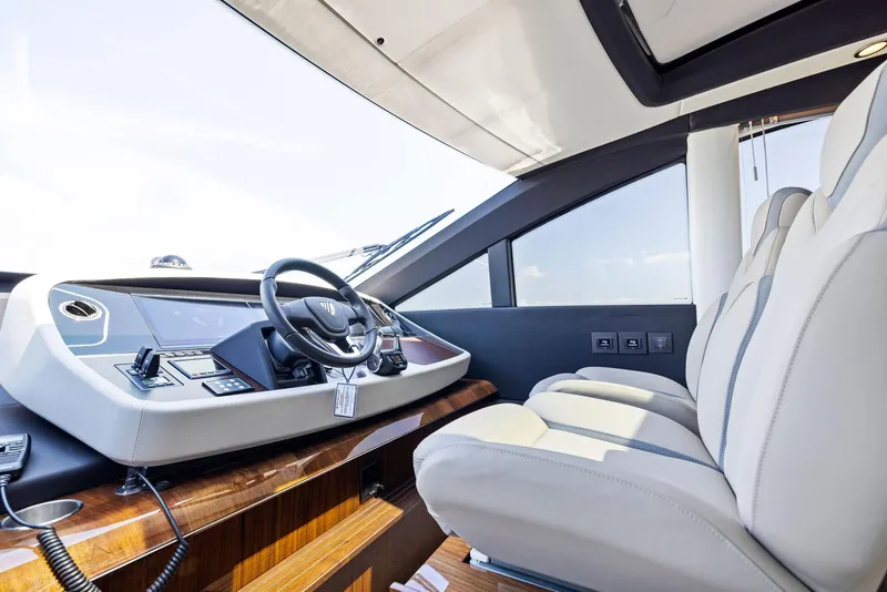 Slide: The Image of 2024 Fairline Phantom 65 yacht cockpit with modern steering and luxurious seating. - 16